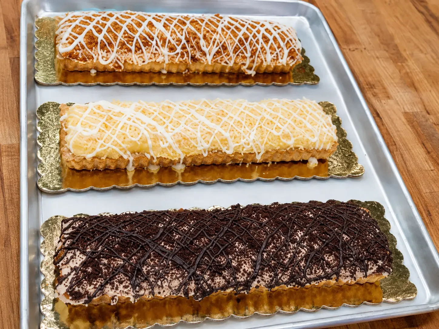 Sliced pastry bars arranged on a bakery tray