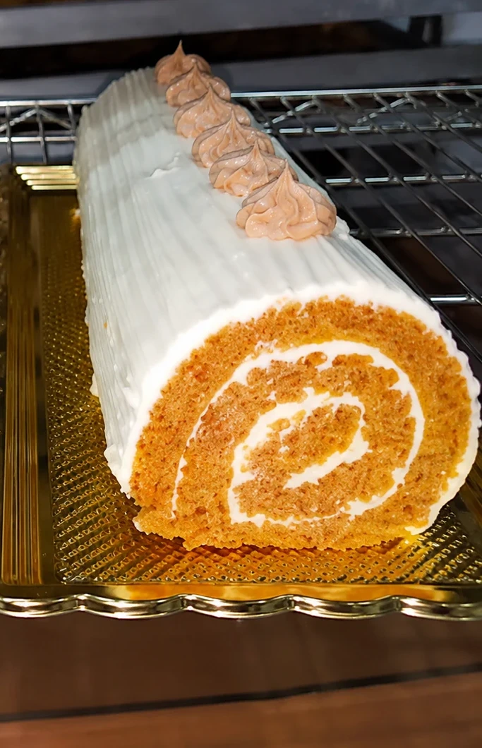 Single pumpkin roll centered in the frame at Sander's Bakery