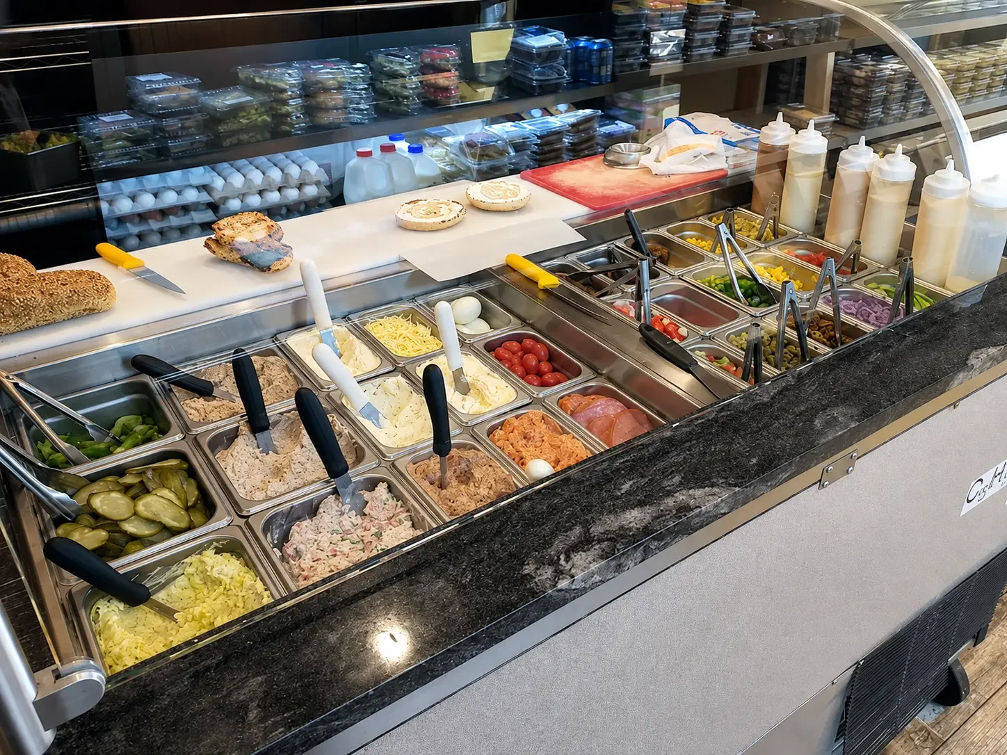 Prepared foods and sandwich station with fresh salads and toppings